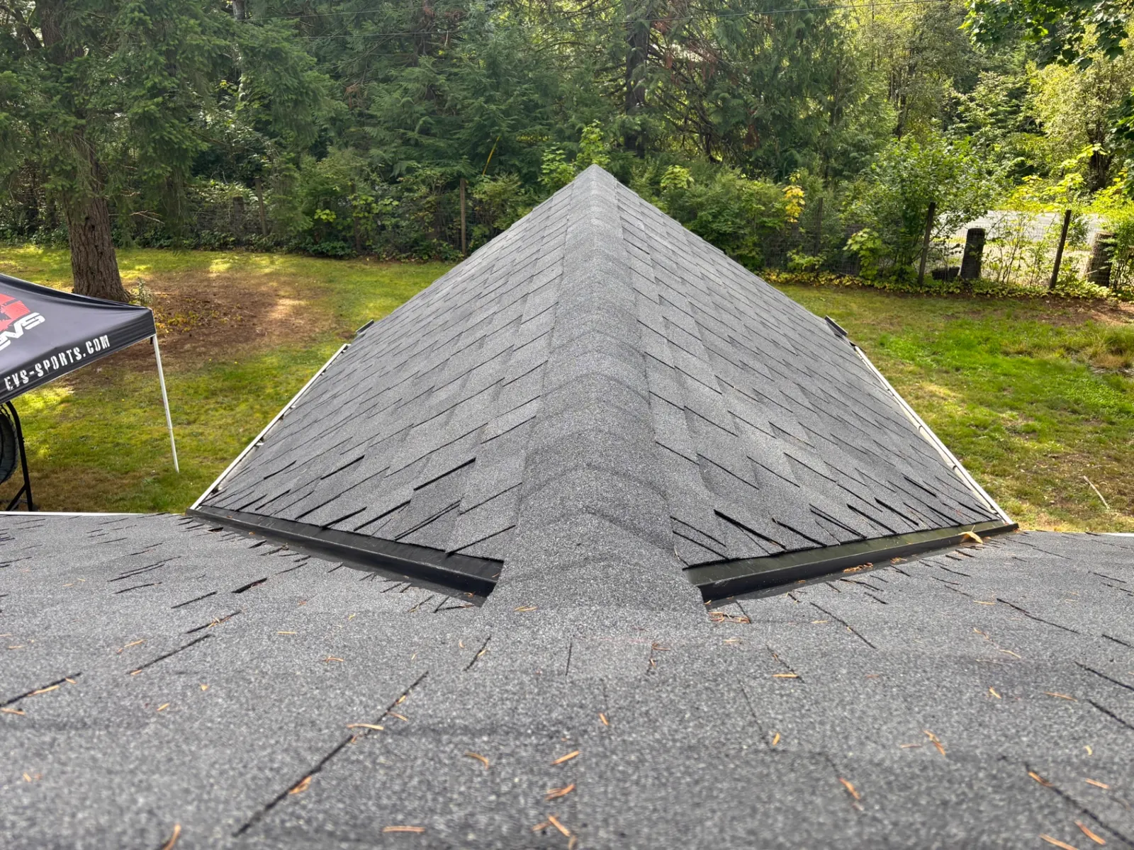 Newly installed black architectural shingle roof with clean hip lines